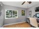 Bedroom with light hardwood floors, a bright window, a ceiling fan and an adjacent desk area at 1417 Borg Ln, Winter Springs, FL 32708