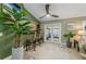 Bright dining area features three bar stools, tiled floors, ceiling fan, and French doors leading to the patio at 1417 Borg Ln, Winter Springs, FL 32708