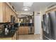 Bright, open kitchen with stainless steel appliances, stone backsplash, and stylish cabinetry at 1417 Borg Ln, Winter Springs, FL 32708