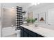 Bathroom with shower/tub combo, black vanity, and buffalo check curtain at 1977 Tohoqua Blvd, Kissimmee, FL 34744