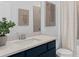 Modern bathroom with blue vanity and neutral decor at 1977 Tohoqua Blvd, Kissimmee, FL 34744