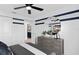 Bedroom with dresser, large mirror, and adjacent bathroom at 1977 Tohoqua Blvd, Kissimmee, FL 34744