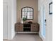 Modern entryway featuring a console table and arched mirror at 1977 Tohoqua Blvd, Kissimmee, FL 34744
