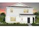 Two-story house with white siding, dark gray roof, and landscaping at 1977 Tohoqua Blvd, Kissimmee, FL 34744