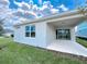 Enjoy the covered patio, perfect for outdoor entertaining, and the green lawn, creating a serene backyard retreat at 2206 Lovely Ln, Davenport, FL 33897