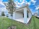 The backyard offers a spacious covered patio and lush green lawn, ideal for relaxing and entertaining outdoors at 2206 Lovely Ln, Davenport, FL 33897