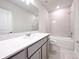 Bathroom featuring a vanity with stone countertop, bathtub, and tiled shower at 2206 Lovely Ln, Davenport, FL 33897