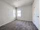Comfortable bedroom features carpeted flooring, two windows, and a closet at 2206 Lovely Ln, Davenport, FL 33897