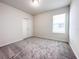 Bright bedroom with carpeted floors, closet, and a window for natural light at 2206 Lovely Ln, Davenport, FL 33897