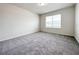 Bright bedroom features a plush carpet and a window letting in natural light at 2206 Lovely Ln, Davenport, FL 33897