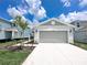 Well-maintained home featuring a gray exterior, a two-car garage, and a concrete driveway at 2206 Lovely Ln, Davenport, FL 33897