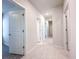 Hallway with white doors and trim, and modern tile flooring throughout at 2206 Lovely Ln, Davenport, FL 33897