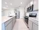 Bright kitchen with an island, stainless steel appliances, and shaker-style cabinets at 2206 Lovely Ln, Davenport, FL 33897