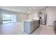 Modern kitchen features an island, stainless steel appliances, and sliding glass doors to the backyard at 2206 Lovely Ln, Davenport, FL 33897