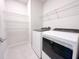 Well-equipped laundry room features modern appliances and wire shelving at 2206 Lovely Ln, Davenport, FL 33897