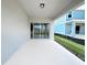 A covered patio with a concrete floor, and sliding glass doors, perfect for enjoying outdoor living and entertaining at 2206 Lovely Ln, Davenport, FL 33897