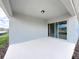 View of the covered patio, sliding glass doors, and neutral paint create a comfortable and inviting outdoor space at 2206 Lovely Ln, Davenport, FL 33897