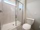 Walk-in shower with glass door, tiled walls, and a built-in niche at 2206 Lovely Ln, Davenport, FL 33897