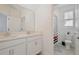 Well-lit bathroom showcasing double sinks and modern fixtures at 2429 Volunteer Ave, Kissimmee, FL 34744