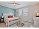 Comfortable bedroom showcasing a ceiling fan, large bed, and neutral tones for a relaxing atmosphere at 2429 Volunteer Ave, Kissimmee, FL 34744