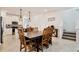 An open-concept dining room with white walls, pendant lighting, and a long table with chairs at 2429 Volunteer Ave, Kissimmee, FL 34744
