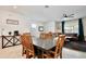 Open concept dining and living area with a large table and green curtains. Lots of space! at 2429 Volunteer Ave, Kissimmee, FL 34744