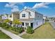 Inviting two-story home featuring a charming front porch with stylish outdoor seating and a beautifully landscaped yard at 2429 Volunteer Ave, Kissimmee, FL 34744