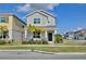 Charming two-story home featuring lush landscaping, an inviting front porch, and a freshly manicured lawn at 2429 Volunteer Ave, Kissimmee, FL 34744