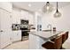 A modern kitchen with white cabinetry, stainless steel appliances, and a large island with bar seating at 2429 Volunteer Ave, Kissimmee, FL 34744