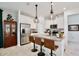 Modern kitchen featuring stainless steel appliances, a kitchen island, and a stylish hanging pendant lighting at 2429 Volunteer Ave, Kissimmee, FL 34744