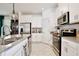 Modern kitchen featuring stainless steel appliances and white cabinets at 2429 Volunteer Ave, Kissimmee, FL 34744