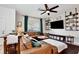 Comfortable living area features a plush leather sofa, stylish shelving, and a flat screen television at 2429 Volunteer Ave, Kissimmee, FL 34744