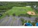 Aerial view of a community park featuring a baseball field, parking, and a playground, offering various recreational activities at 2438 River Rise Ct, Orlando, FL 32828