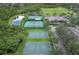 Aerial view showcasing basketball courts and tennis courts, surrounded by lush greenery and scenic ponds at 2438 River Rise Ct, Orlando, FL 32828