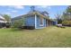 Exterior view of a home with a large fenced backyard and a charming seating area at 2438 River Rise Ct, Orlando, FL 32828