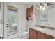 Bathroom with granite countertops, a door to the backyard, and a well-lit vanity area at 2438 River Rise Ct, Orlando, FL 32828