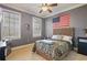 A bedroom with gray walls, a queen size bed, and an American flag on the wall at 2438 River Rise Ct, Orlando, FL 32828