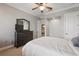 Bedroom with a bed, dresser with mirror, and an open doorway to another room at 2438 River Rise Ct, Orlando, FL 32828