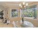 Bright dining area with natural light and views of the outdoor landscape at 2438 River Rise Ct, Orlando, FL 32828
