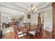 Dining room featuring crown molding and a view of staircase and living room at 2438 River Rise Ct, Orlando, FL 32828