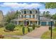 Charming two-story home with a copper roof, lush landscaping, and solar panels at 2438 River Rise Ct, Orlando, FL 32828