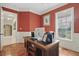 A home office featuring hardwood floors, wainscoting, and a large window for natural light at 2438 River Rise Ct, Orlando, FL 32828