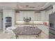 Gourmet kitchen featuring granite counters, custom cabinets, and stainless-steel appliances at 2438 River Rise Ct, Orlando, FL 32828
