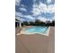 Community pool featuring clear blue water and a spacious deck area for lounging in the sun at 2438 River Rise Ct, Orlando, FL 32828