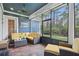 Relaxing screened porch with comfortable seating and a view of the backyard at 2438 River Rise Ct, Orlando, FL 32828