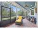 Inviting screened porch with a view of the backyard, featuring comfortable seating at 2438 River Rise Ct, Orlando, FL 32828