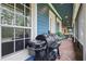 Relaxing screened porch with brick floors, ceiling fans, and outdoor grill at 2438 River Rise Ct, Orlando, FL 32828