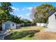 Large backyard featuring a storage shed, a white fence, and a grassy area at 309 Oakwood Ct, Lake Mary, FL 32746