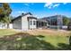Home exterior showcasing a gray stucco with an enclosed pool in the backyard at 309 Oakwood Ct, Lake Mary, FL 32746