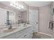 Bright bathroom featuring a double sink vanity with a mirror, drawers, and a door to a shower at 309 Oakwood Ct, Lake Mary, FL 32746